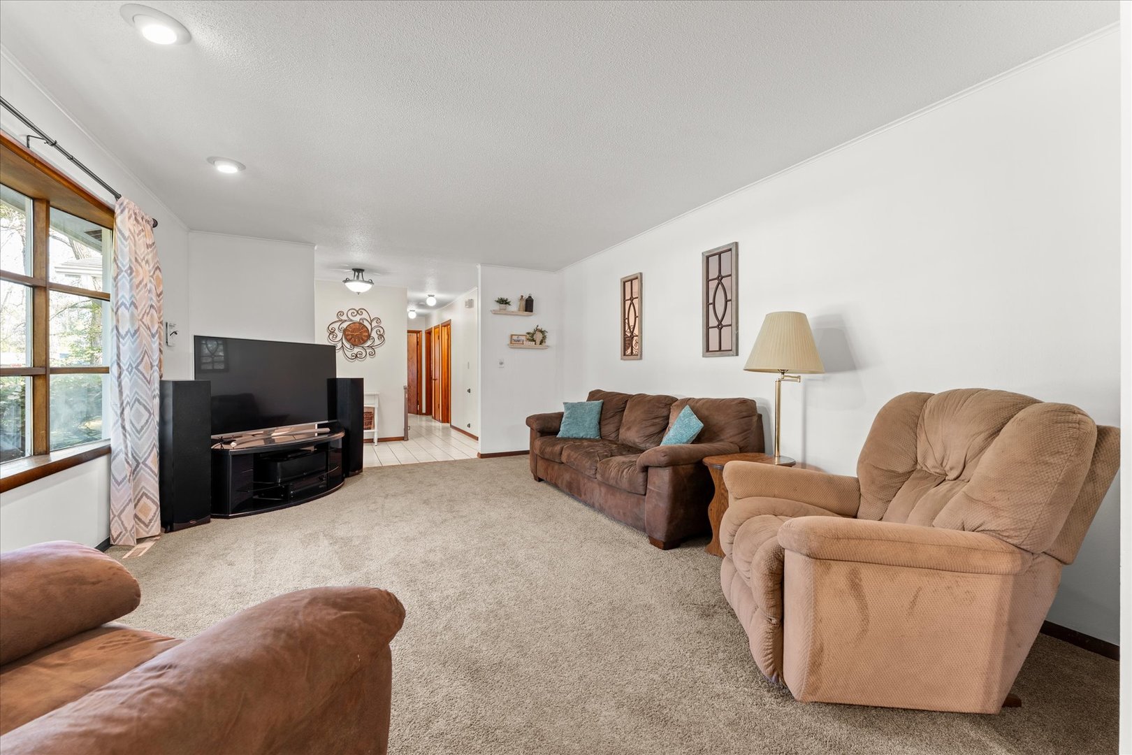 1108 Riverside Court Mahomet, IL 61853 - Photo 7 of 50 a living room with furniture and a flat screen tv