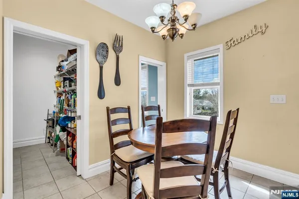 a view of a dining room with furniture and chandelier