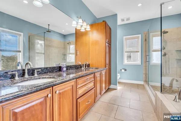a spacious bathroom with a tub and a shower