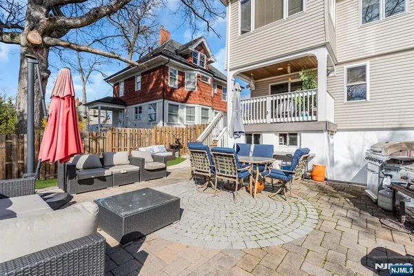 a view of a house with a yard and sitting area