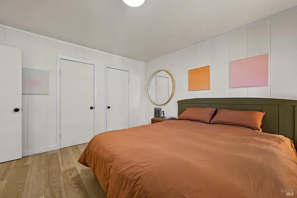 a bedroom with a bed and cabinets