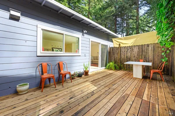 a view of a patio with table and chairs and wooden floor