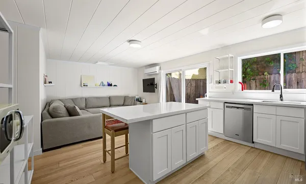 a kitchen with sink stove and refrigerator