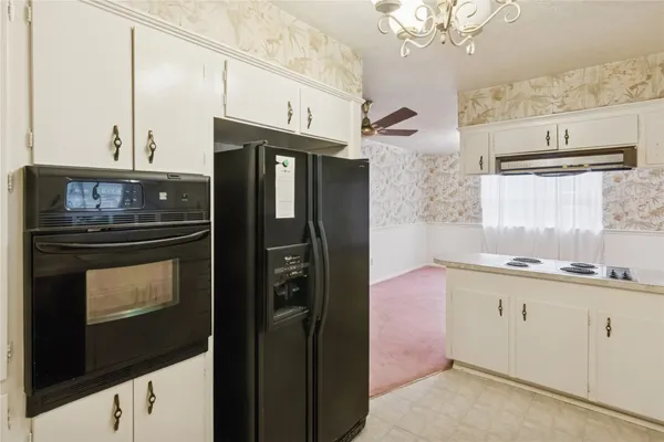 a kitchen with stainless steel appliances a refrigerator a sink and cabinets