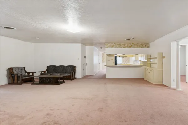 a living room with furniture and a bed
