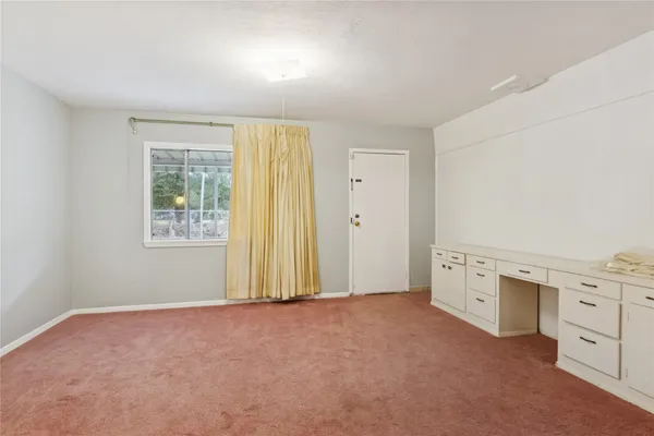 a view of a kitchen with white cabinets