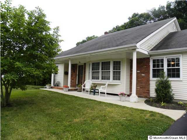 24 Pepperridge Road Howell, NJ 07731 - Photo 1 of 3 a front view of house with a garden and patio