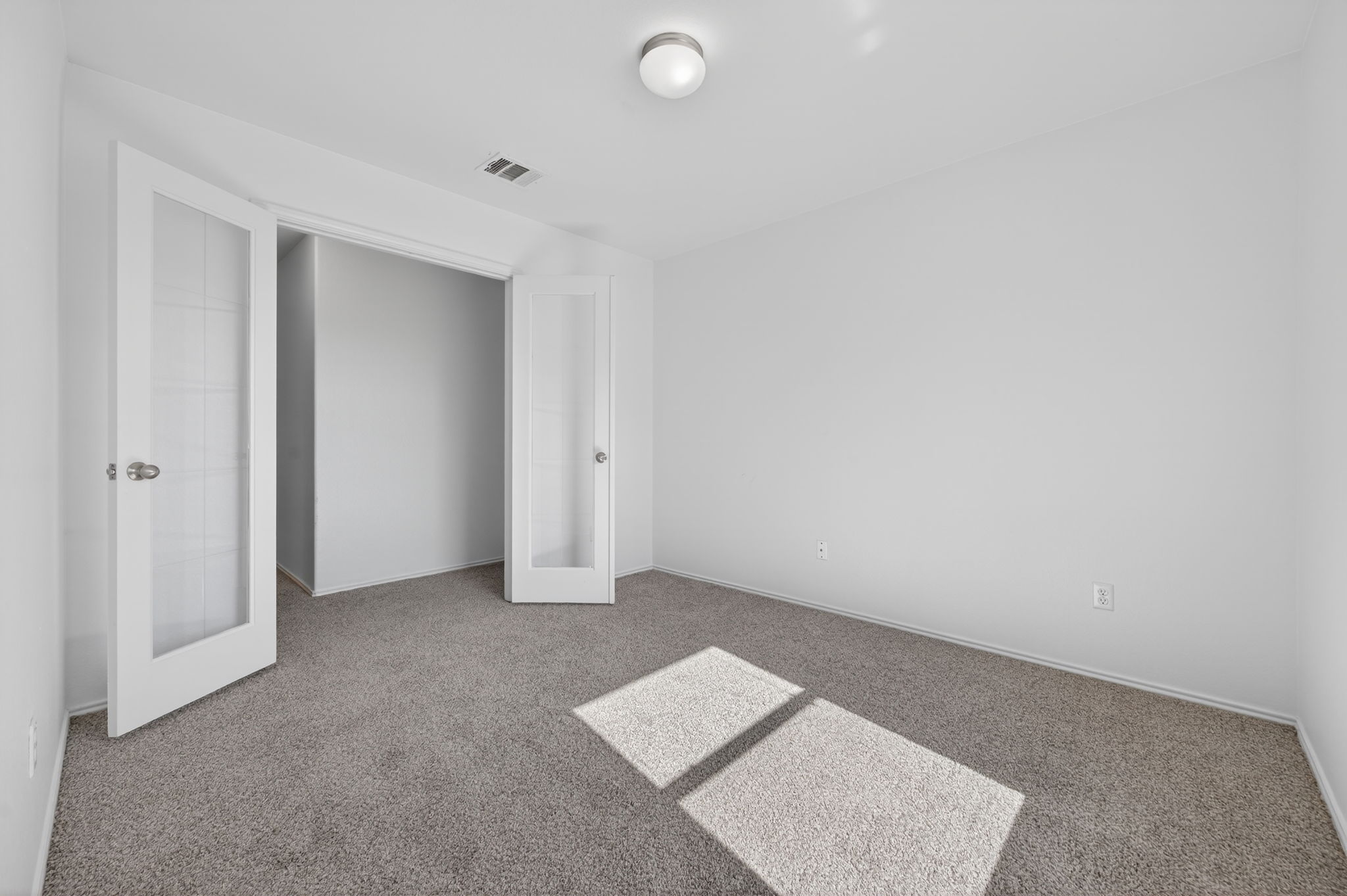 13629 Coomer Path Pflugerville, TX 78660 - Photo 18 of 30 Unfurnished bedroom featuring carpet and french doors