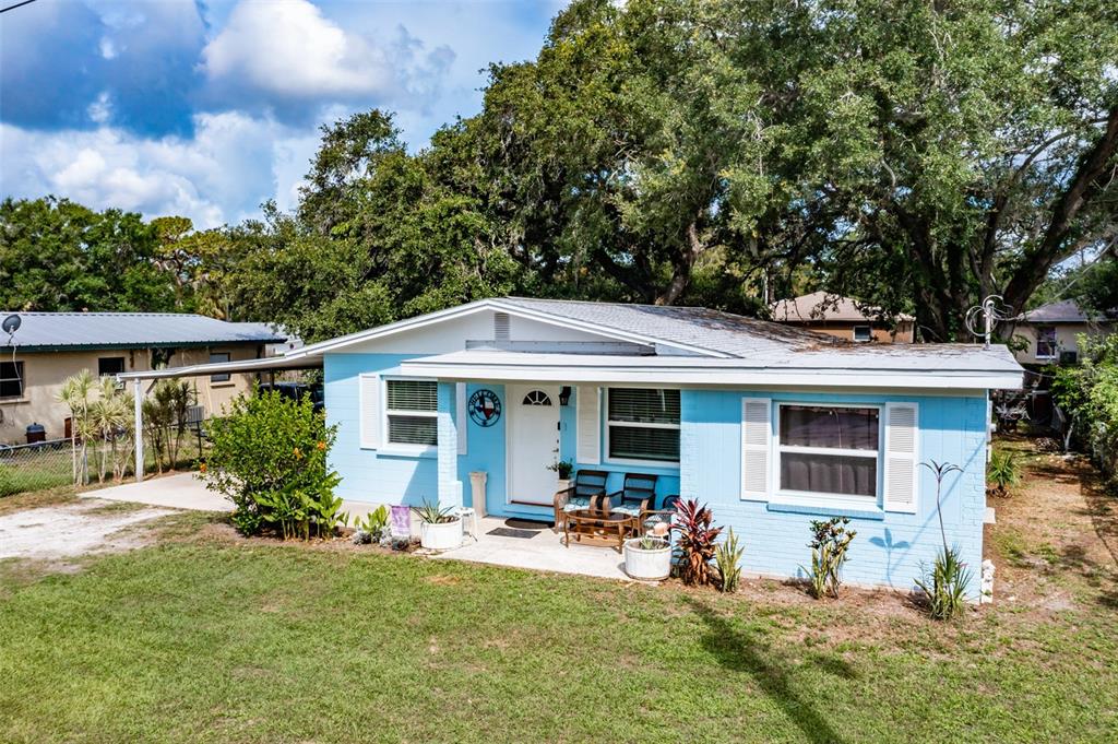 709 Oak Street Southwest Ruskin, FL 33570 - Photo 1 of 1 a view of a patio with table and chairs under an umbrella