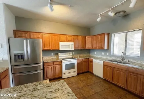 a kitchen with a sink stove and refrigerator