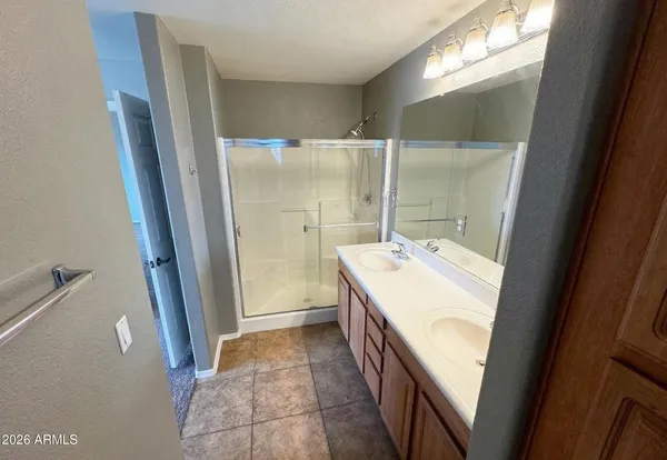 a bathroom with a sink a mirror and a shower