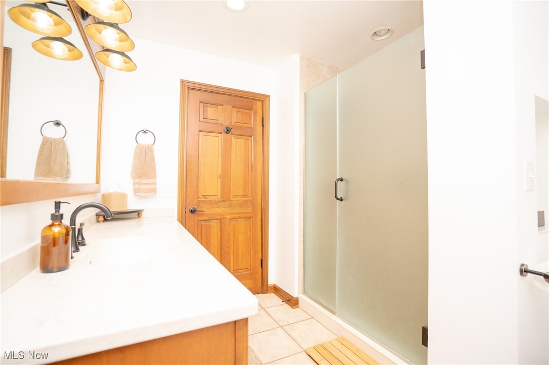 7780 Knauf Road Canfield, OH 44406 - Photo 19 of 48 Bathroom with a shower stall, tile patterned flooring, and vanity