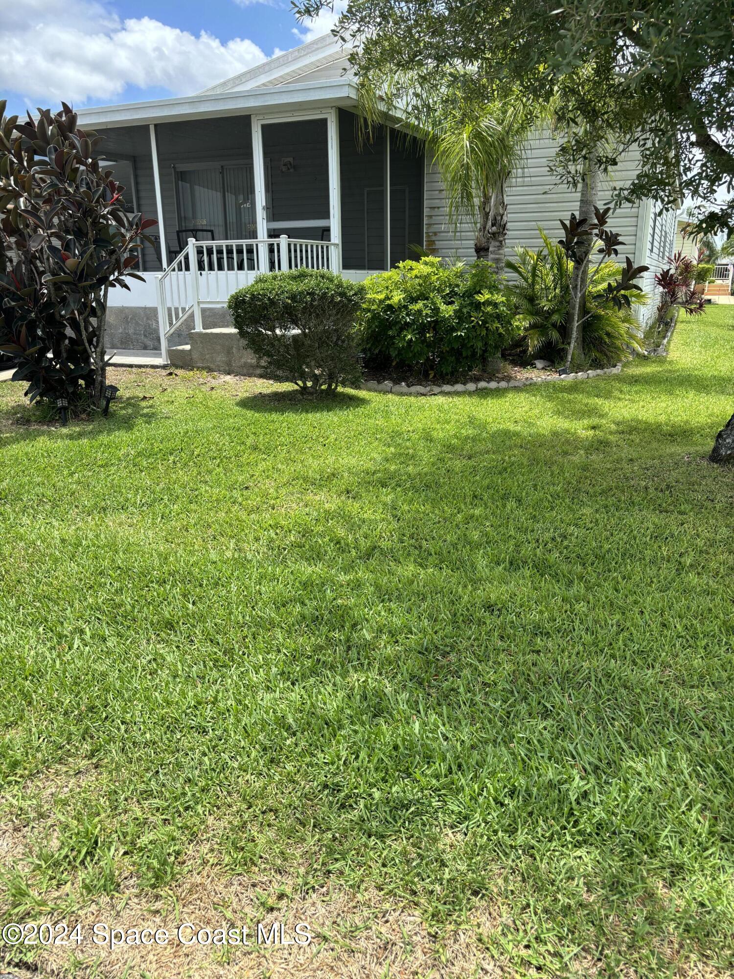 276 Timber Run Way Cocoa, FL 32926 - Photo 1 of 18 a front view of a house with a yard table and chairs