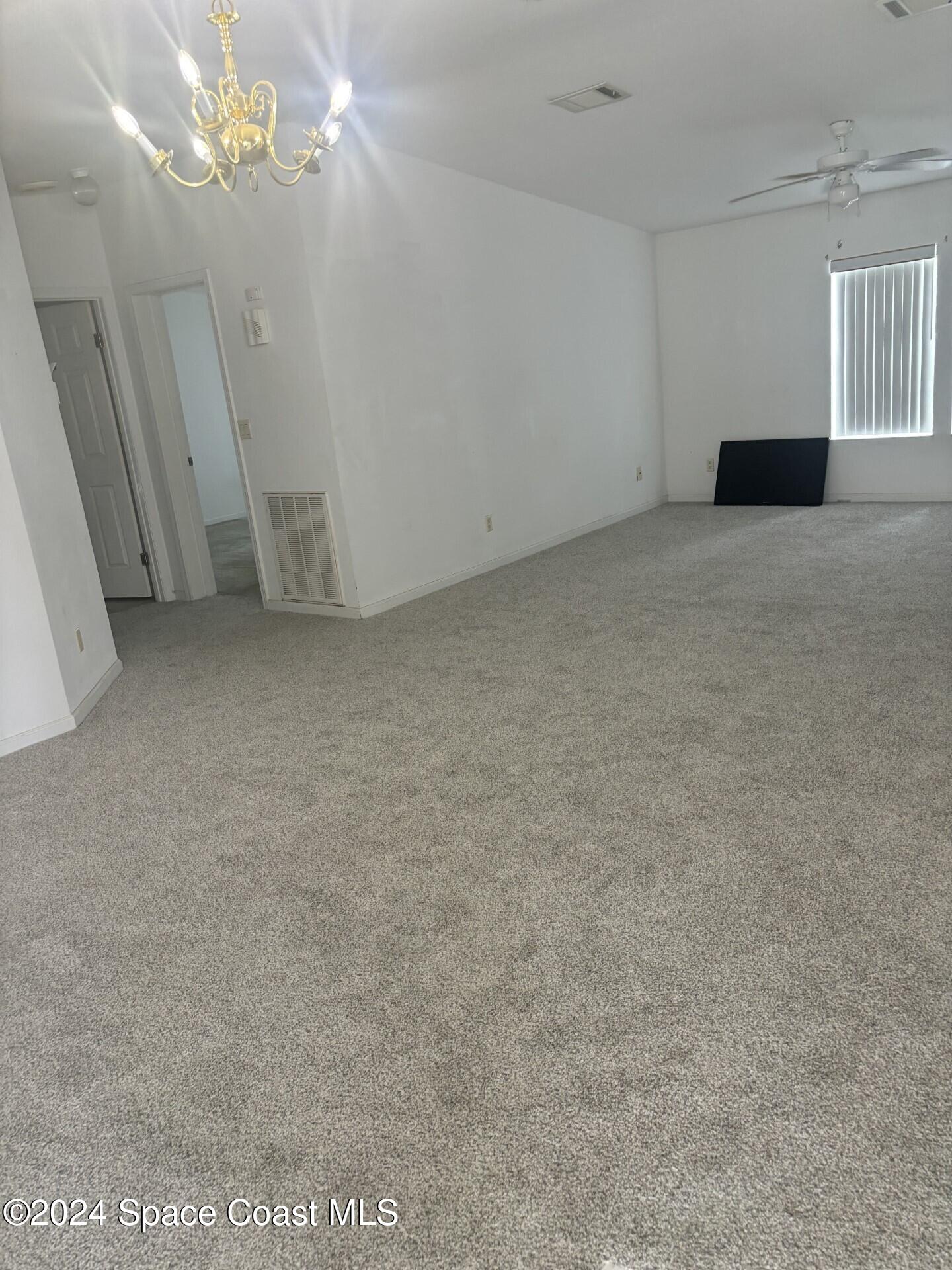 276 Timber Run Way Cocoa, FL 32926 - Photo 18 of 18 a view of a chandelier fan and a refrigerator