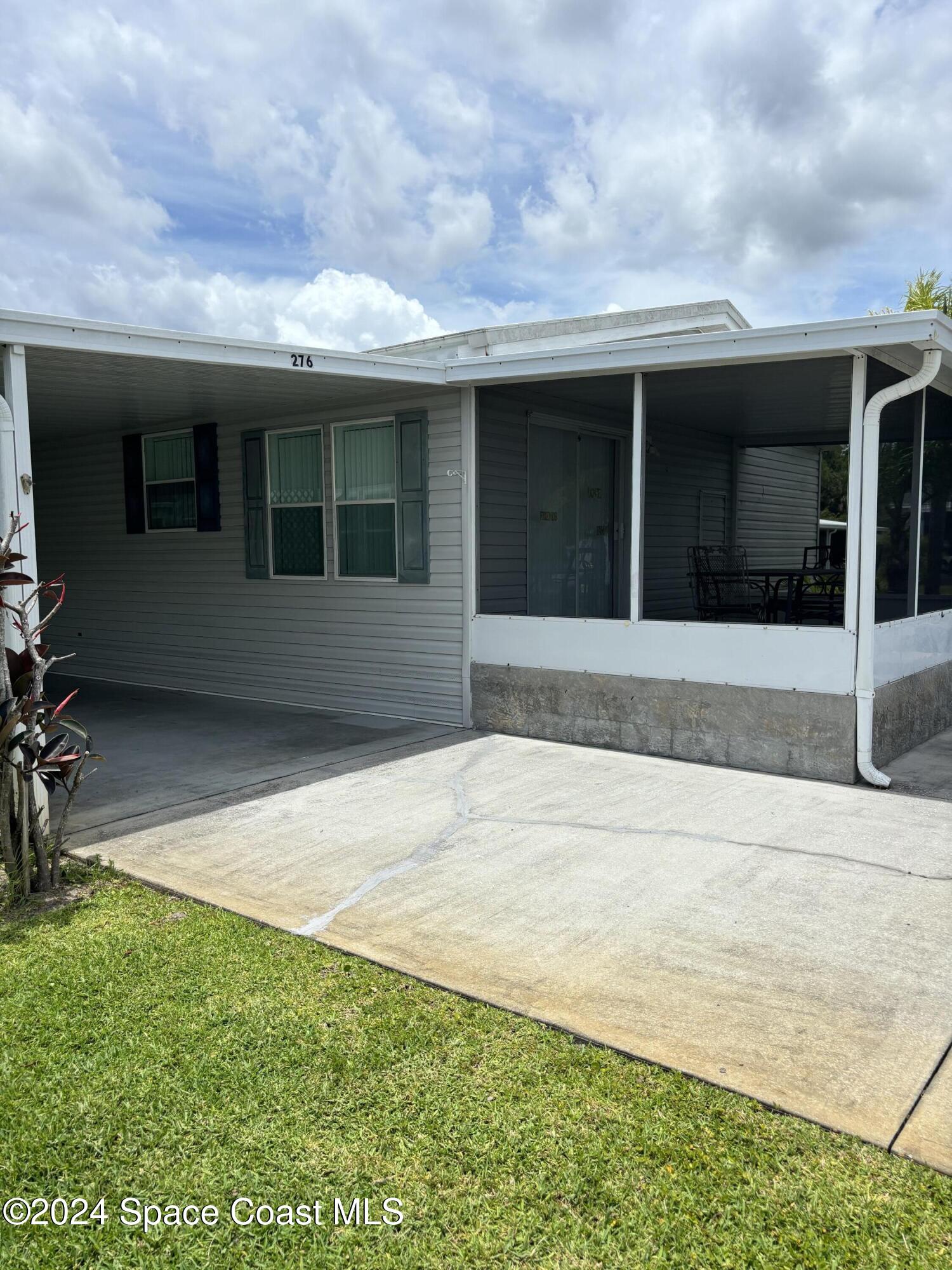 276 Timber Run Way Cocoa, FL 32926 - Photo 3 of 18 a front view of a house with a garden