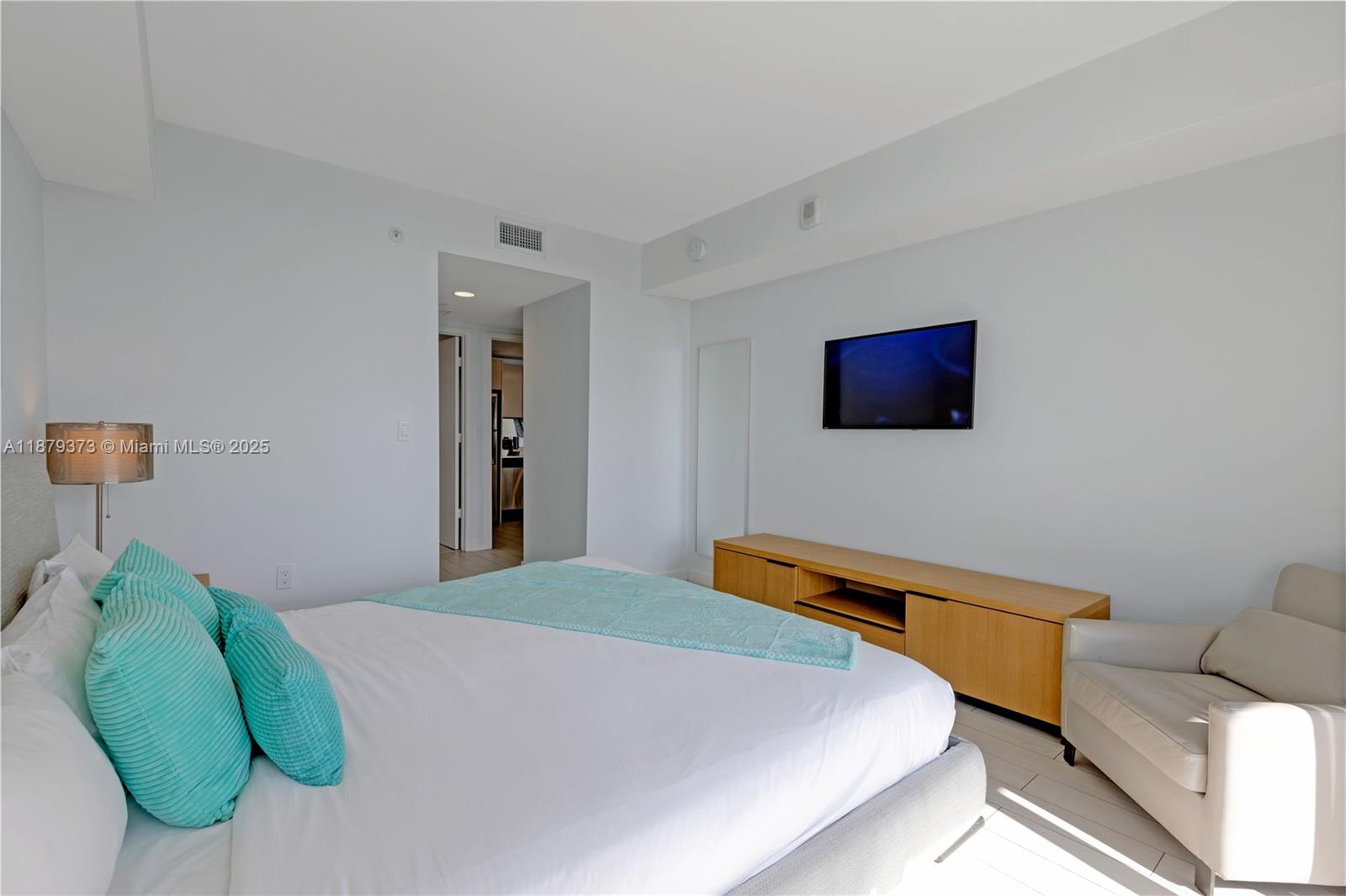 2602 East Hallandale Beach Boulevard, Unit R2109 Hallandale Beach, FL 33009 - Photo 14 of 47 a bedroom with a bed and a television