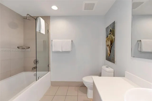 a bathroom with a toilet sink and shower