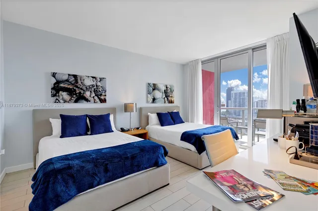 a bedroom with a large bed and a couch