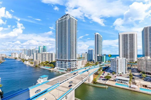 a view of swimming pool with outdoor seating and city view