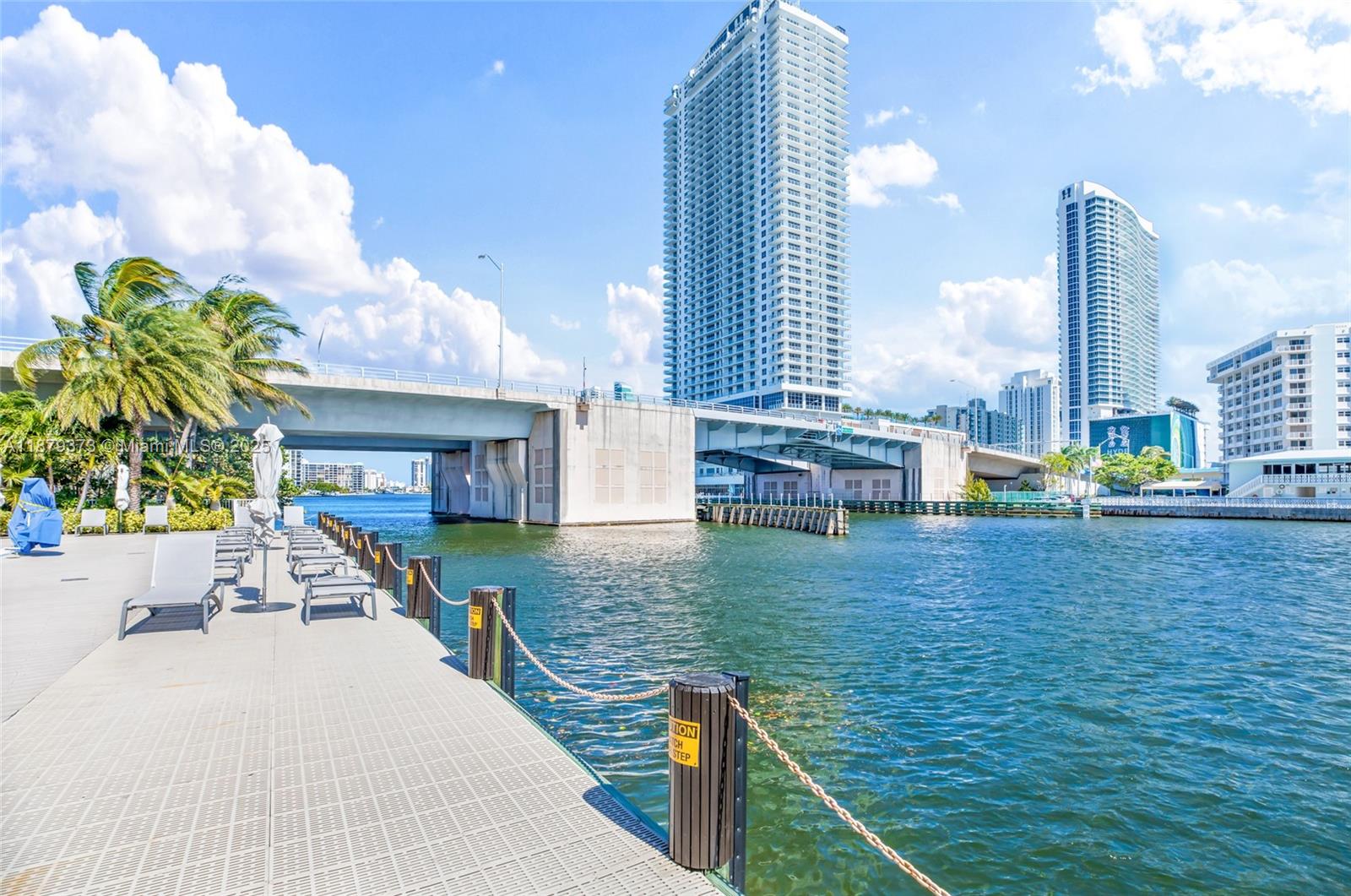 2602 East Hallandale Beach Boulevard, Unit R2109 Hallandale Beach, FL 33009 - Photo 40 of 47 a swimming pool with outdoor seating and yard