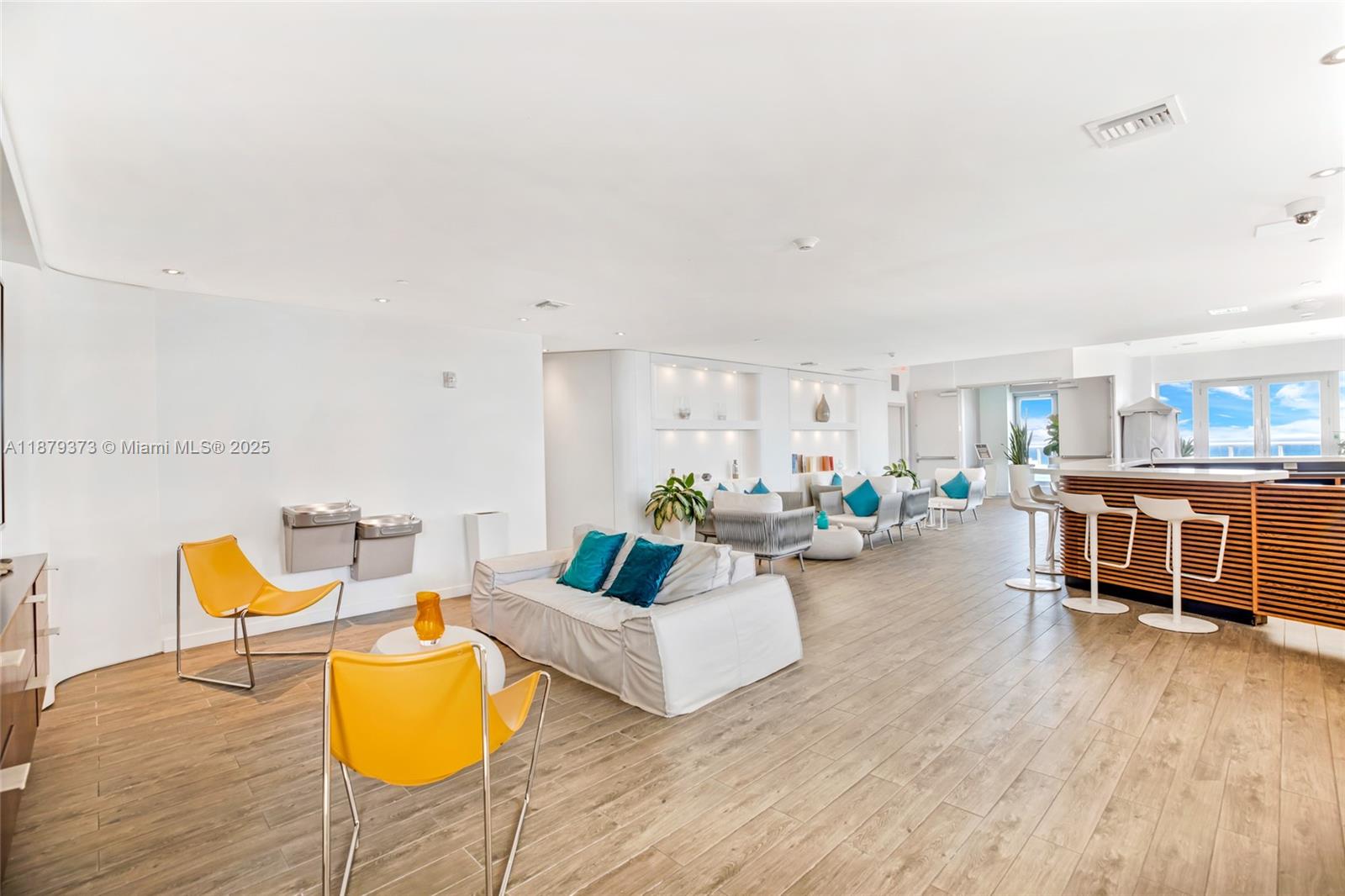2602 East Hallandale Beach Boulevard, Unit R2109 Hallandale Beach, FL 33009 - Photo 41 of 47 a living room with furniture and a wooden floor