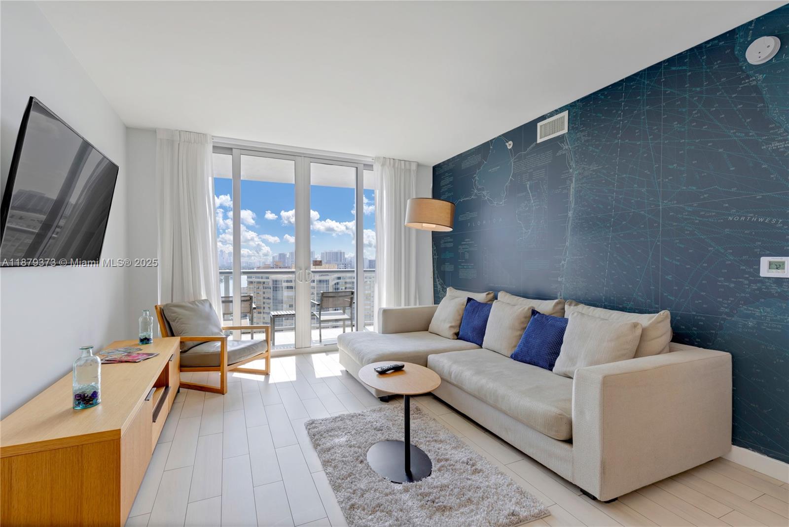 2602 East Hallandale Beach Boulevard, Unit R2109 Hallandale Beach, FL 33009 - Photo 6 of 47 a living room with furniture and a flat screen tv