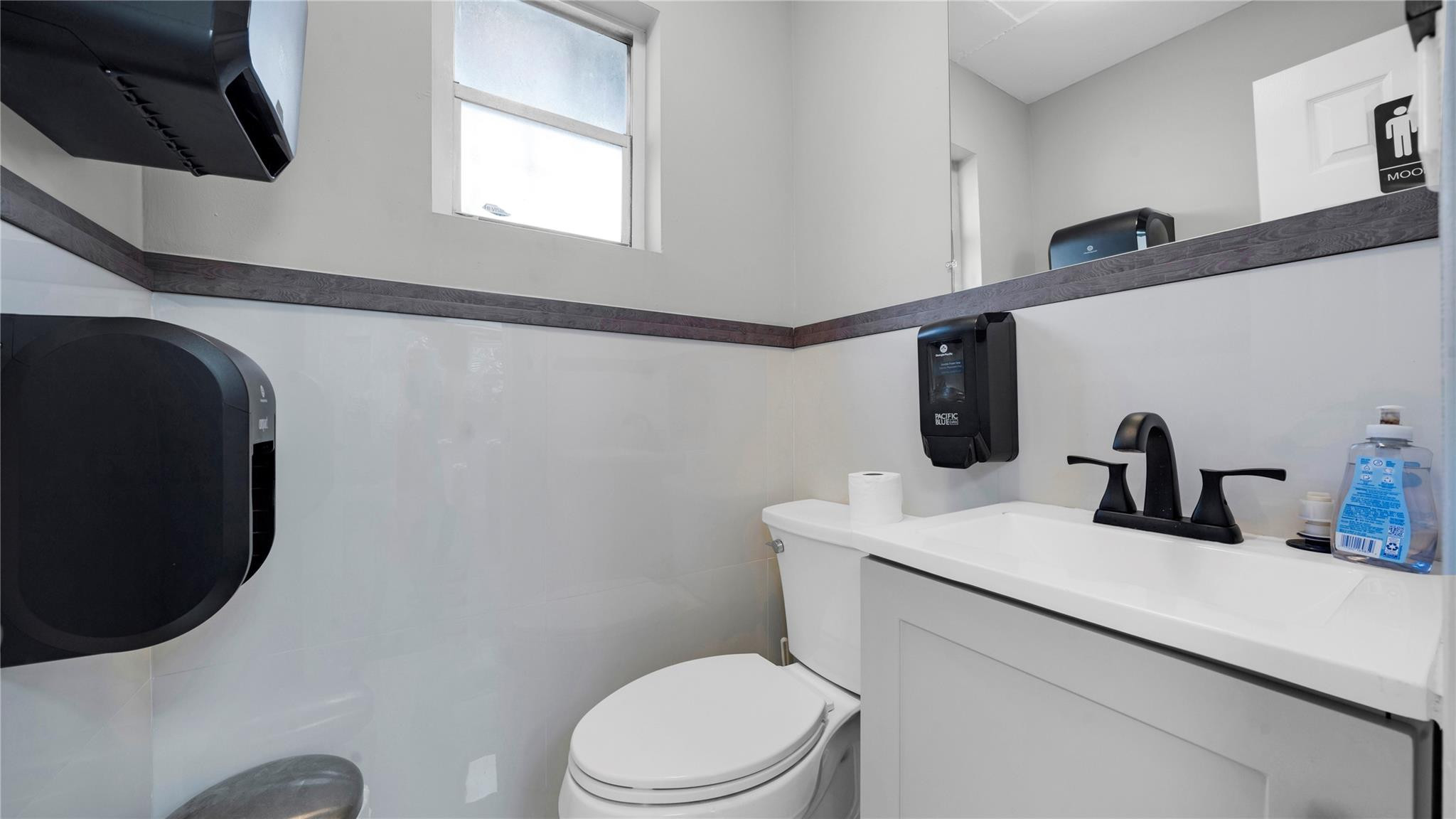 820 Northwest 23rd Street Miami, FL 33127 - Photo 31 of 64 a bathroom with a toilet sink and mirror