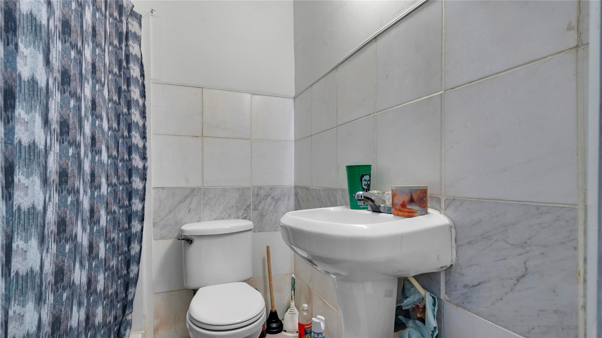 820 Northwest 23rd Street Miami, FL 33127 - Photo 56 of 64 a bathroom with a sink a toilet and mirror