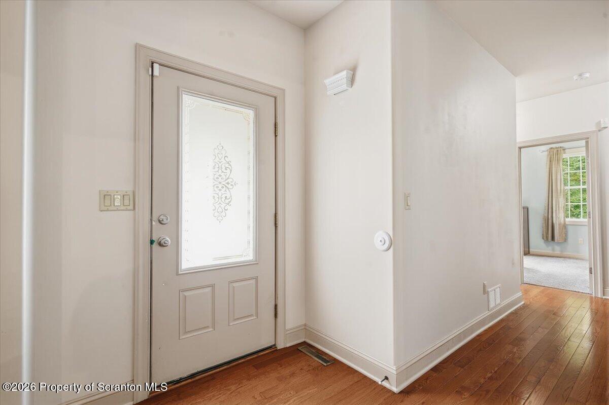 99 Hilltop Road Waverly, PA 18471 - Photo 3 of 41 a view of a hallway with wooden floor