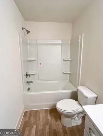 a bathroom with a toilet and a bath tub