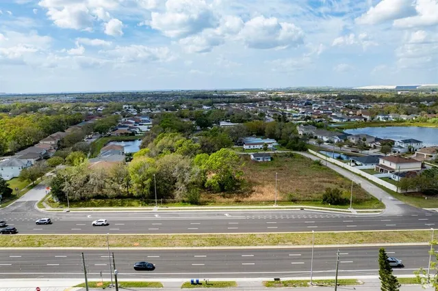 an aerial view of residential houses with yard