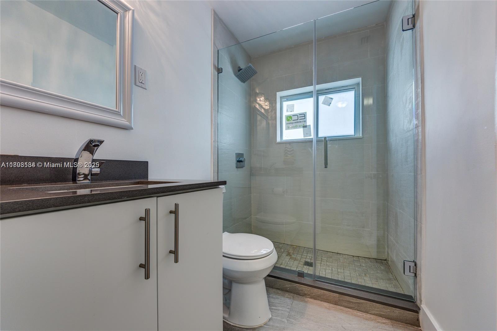 2363 Southwest 21st Terrace Miami, FL 33145 - Photo 13 of 19 a bathroom with a toilet a sink and shower