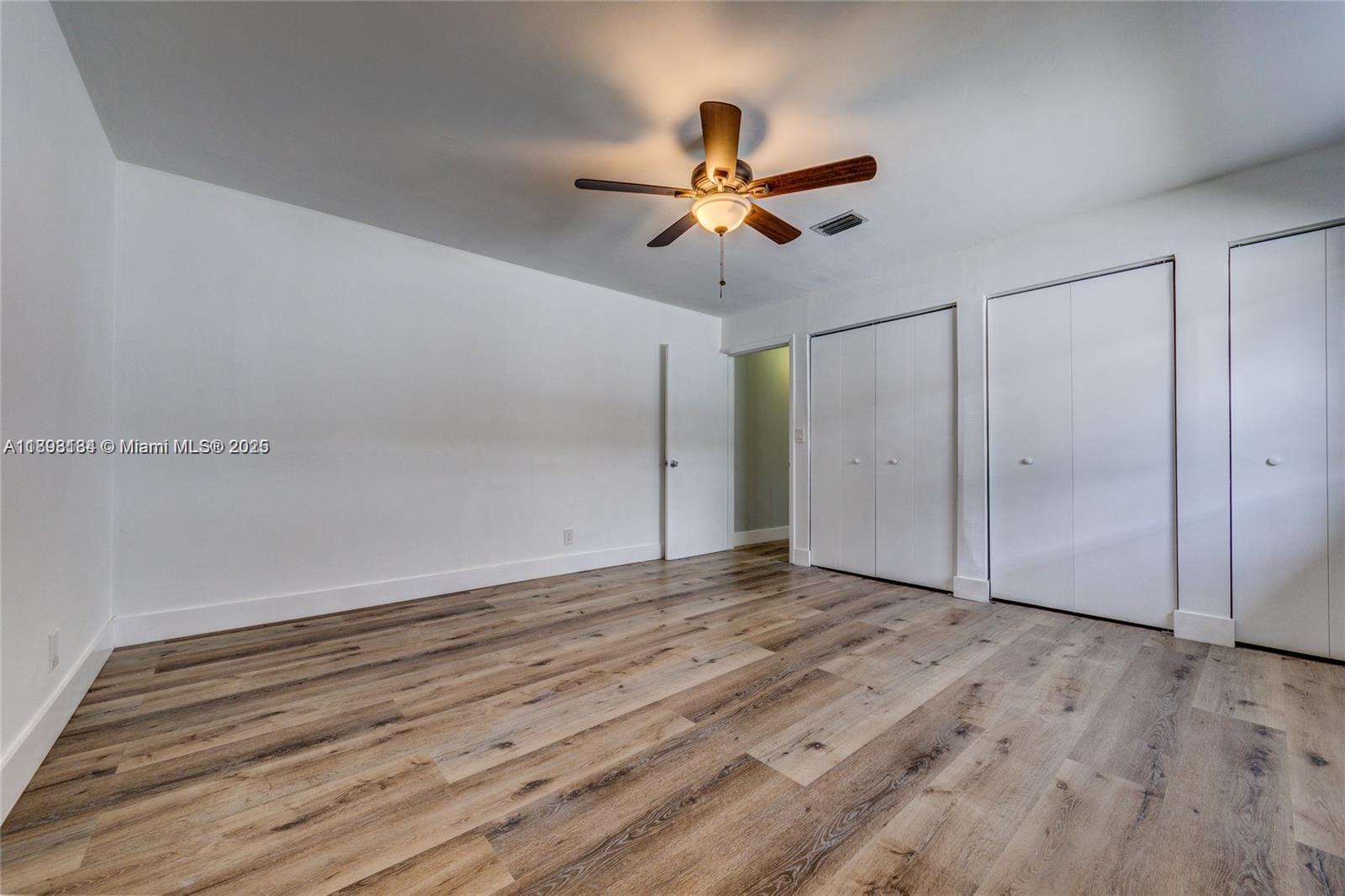 2363 Southwest 21st Terrace Miami, FL 33145 - Photo 14 of 19 a view of empty room with wooden floor and fan