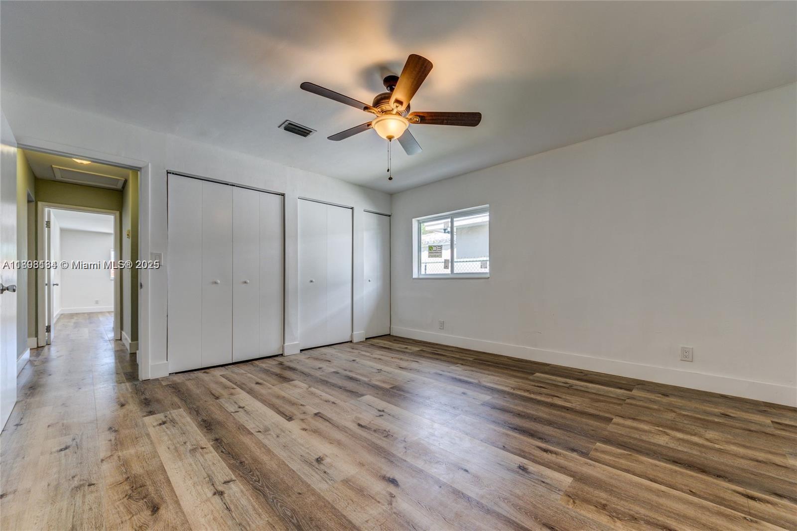2363 Southwest 21st Terrace Miami, FL 33145 - Photo 15 of 19 a view of an empty room with window and wooden floor