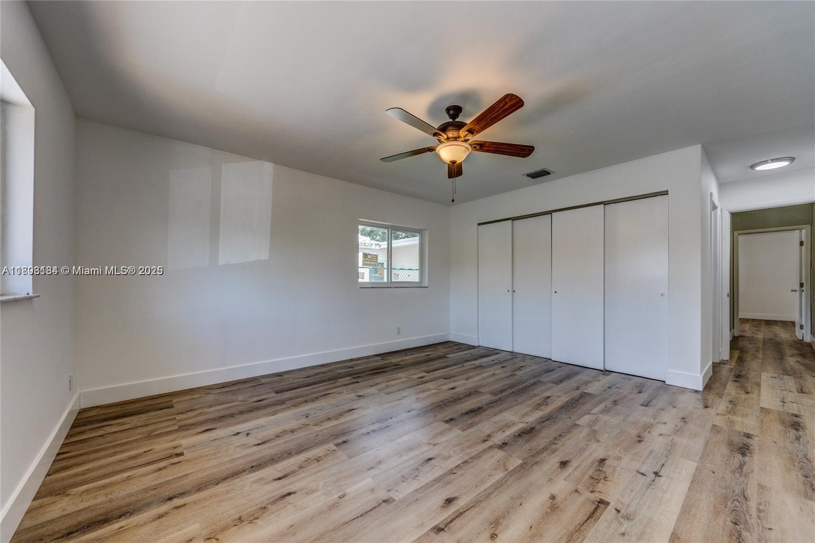 2363 Southwest 21st Terrace Miami, FL 33145 - Photo 17 of 19 a view of empty room with wooden floor and fan