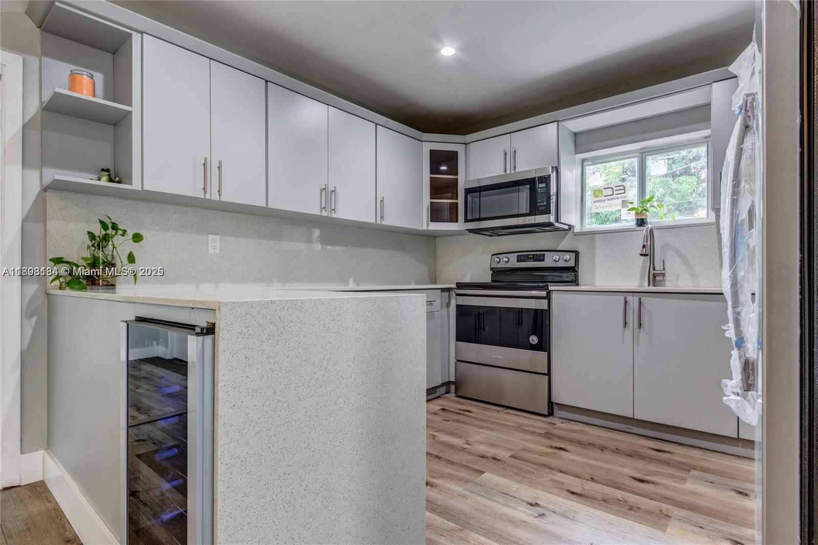 2363 Southwest 21st Terrace Miami, FL 33145 - Photo 4 of 19 a kitchen with granite countertop a refrigerator and a stove top oven