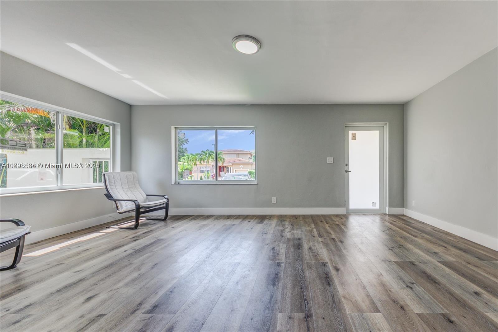 2363 Southwest 21st Terrace Miami, FL 33145 - Photo 7 of 19 wooden floor in an empty room with a window