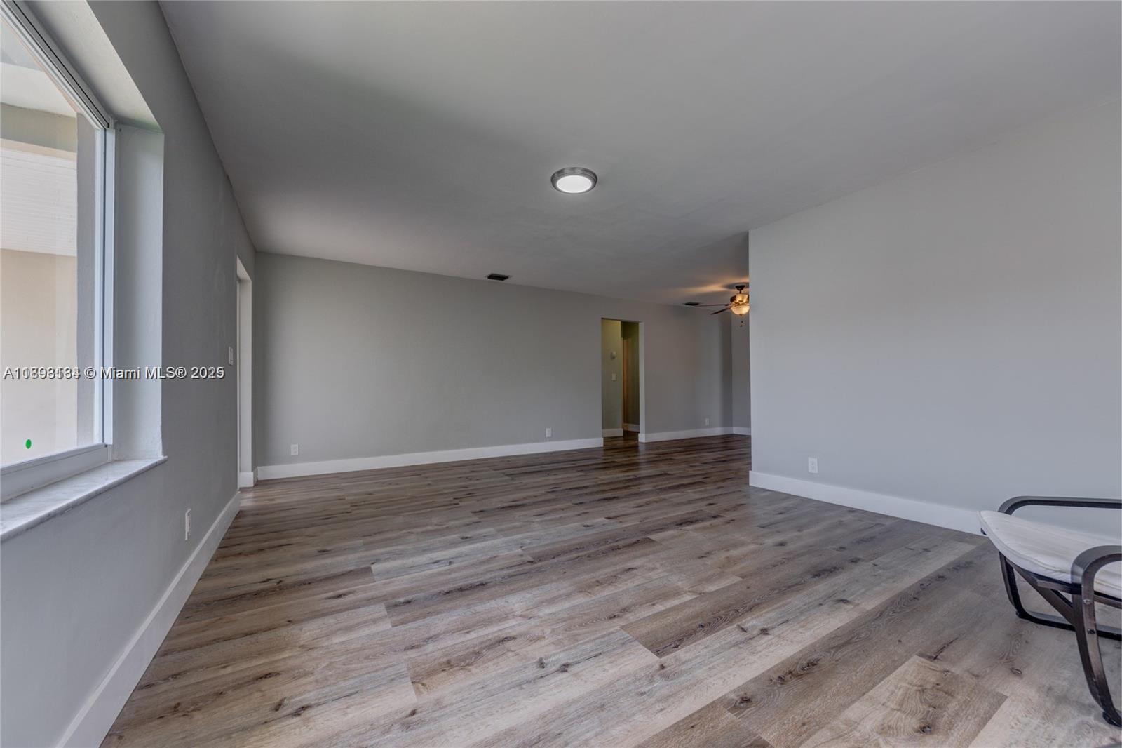 2363 Southwest 21st Terrace Miami, FL 33145 - Photo 8 of 19 a view of an empty room with wooden floor and a window