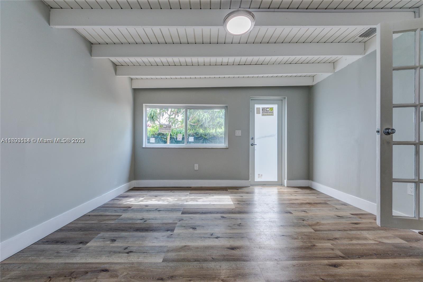 2363 Southwest 21st Terrace Miami, FL 33145 - Photo 10 of 19 a view of an empty room with wooden floor and a window