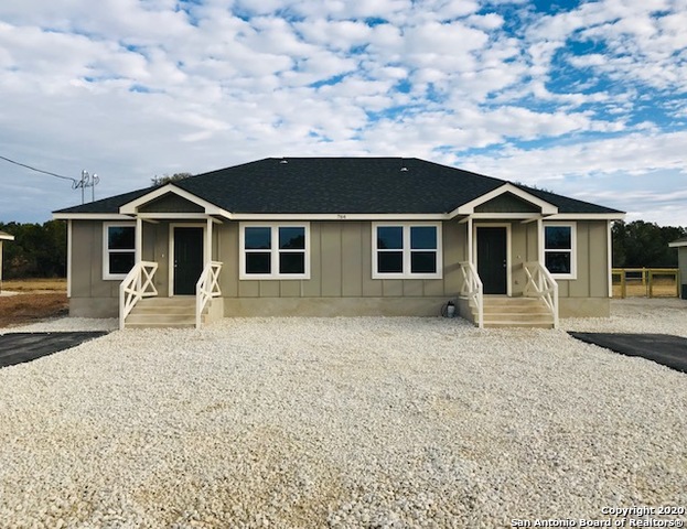752 Cimarron, Unit B Spring Branch, TX 78070 - Photo 1 of 6 a front view of a house with a garden