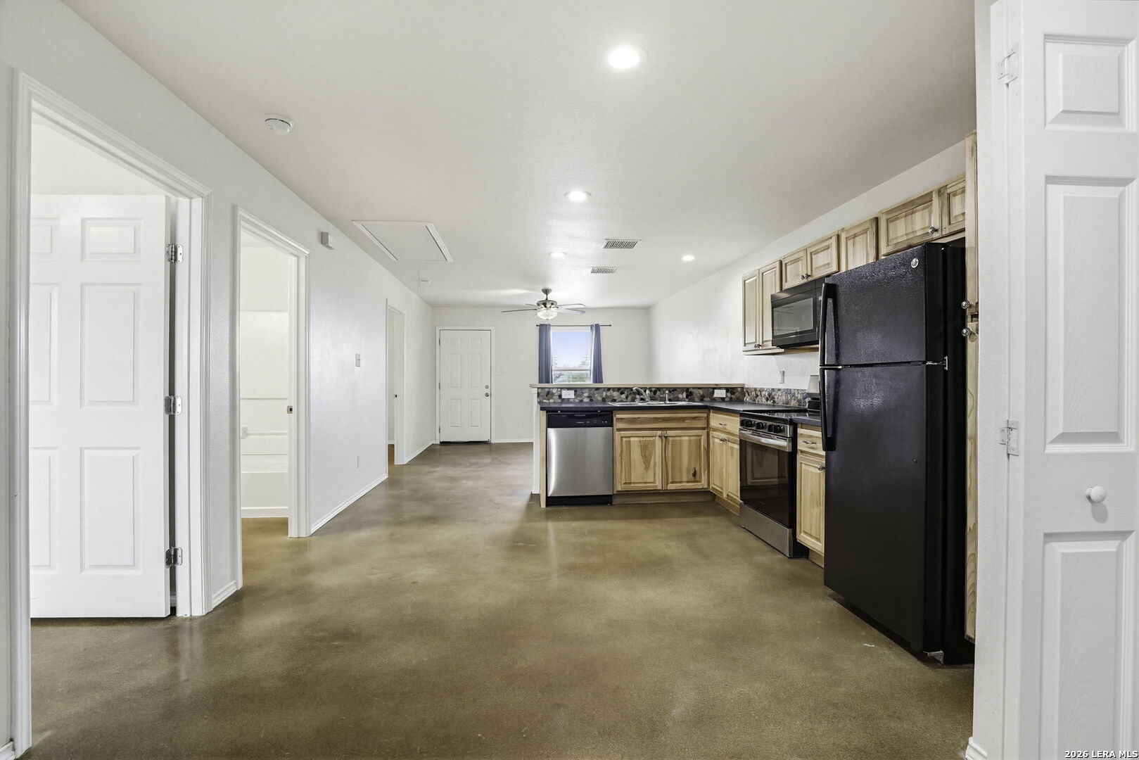 752 Cimarron, Unit B Spring Branch, TX 78070 - Photo 12 of 23 a kitchen with a refrigerator and a stove