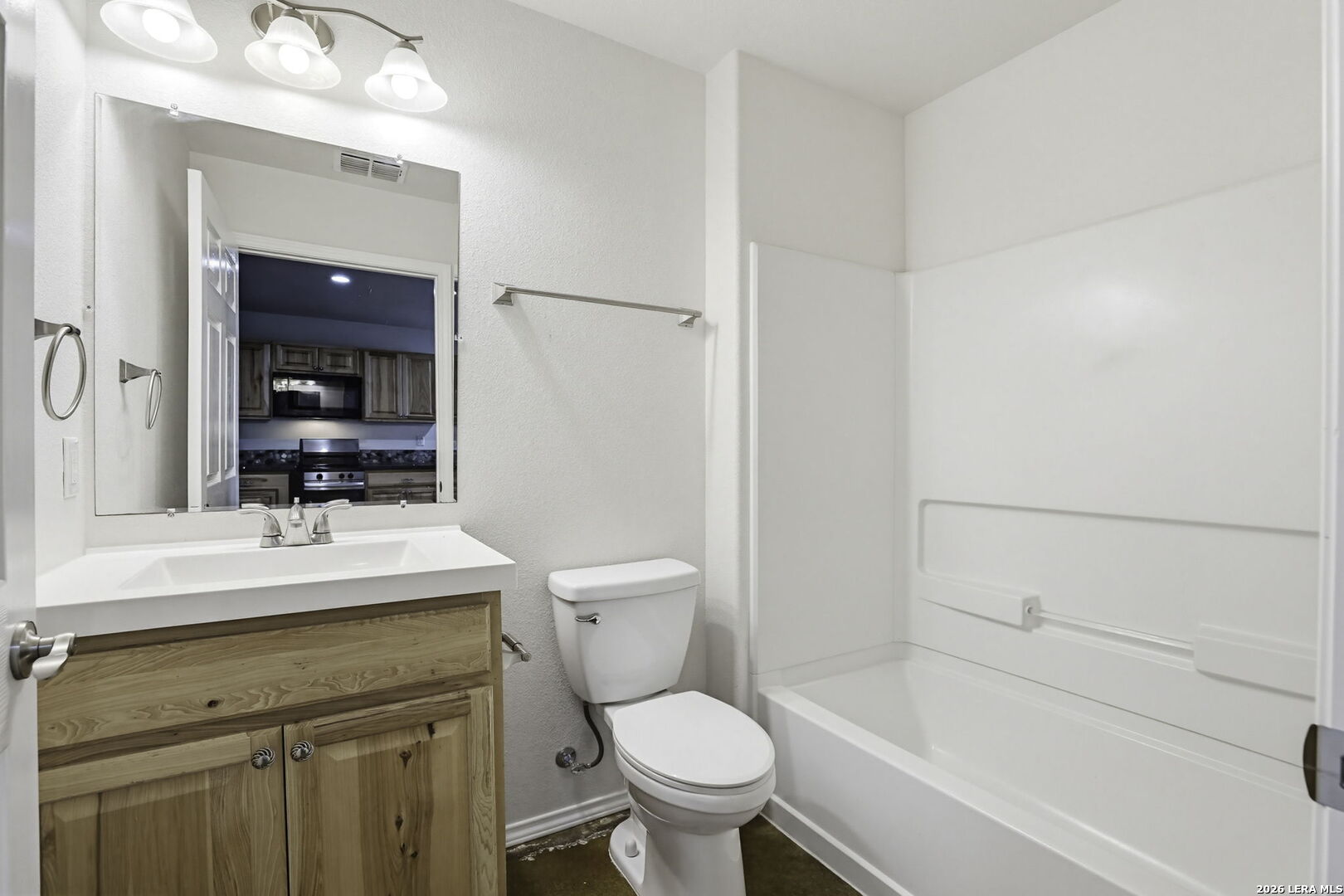 752 Cimarron, Unit B Spring Branch, TX 78070 - Photo 15 of 23 a bathroom with a sink a toilet and shower
