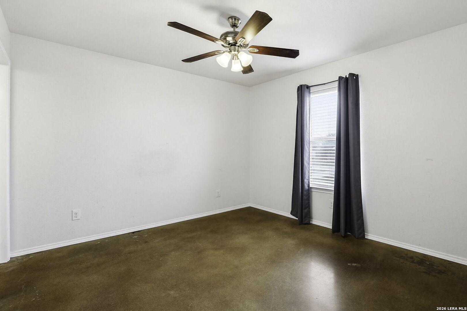752 Cimarron, Unit B Spring Branch, TX 78070 - Photo 16 of 23 an empty room with windows and fan