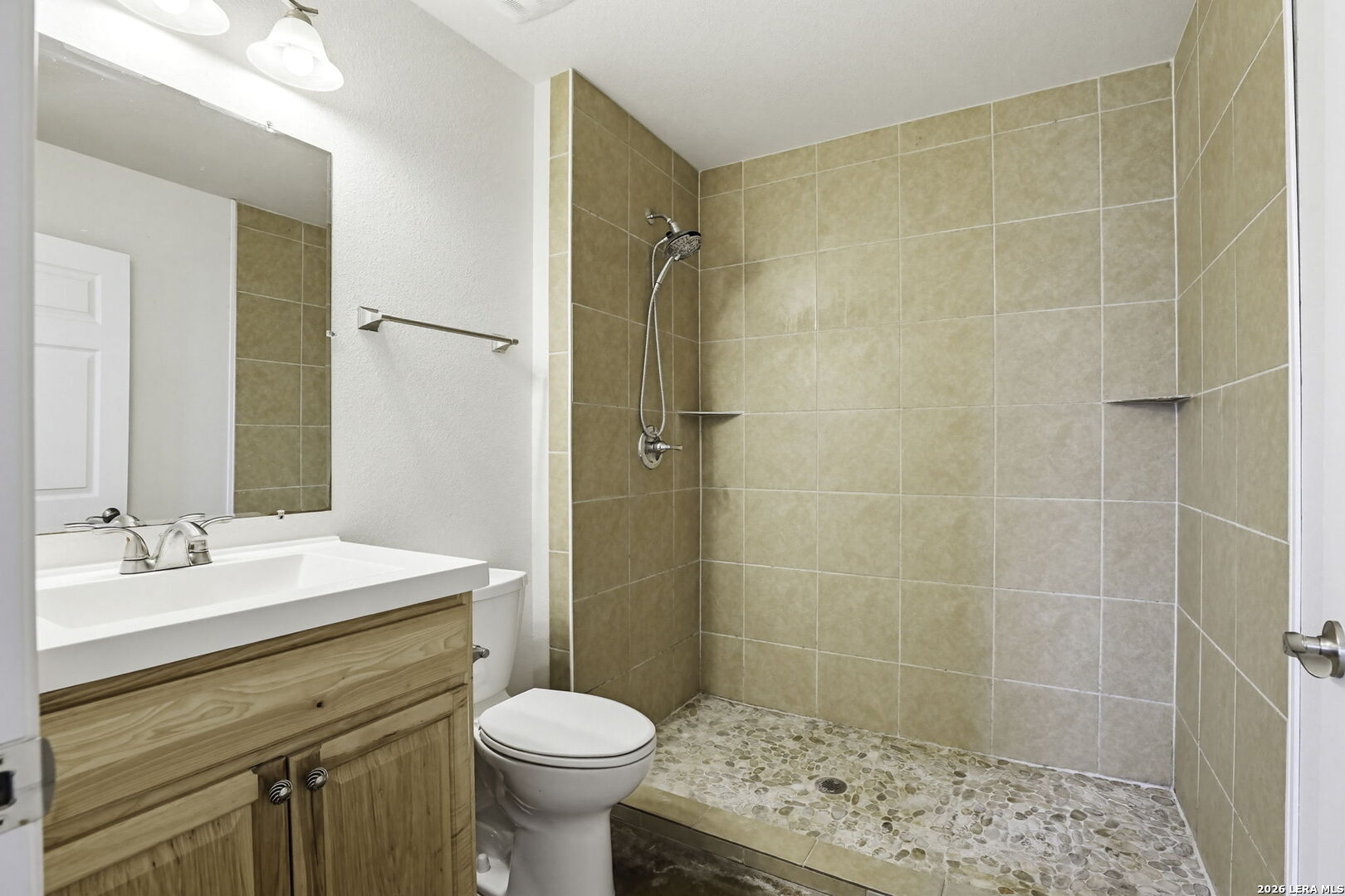 752 Cimarron, Unit B Spring Branch, TX 78070 - Photo 18 of 23 a bathroom with a sink toilet and shower