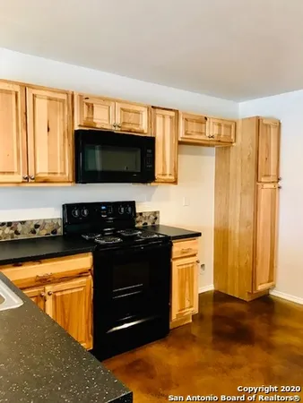a kitchen with a stove and a microwave