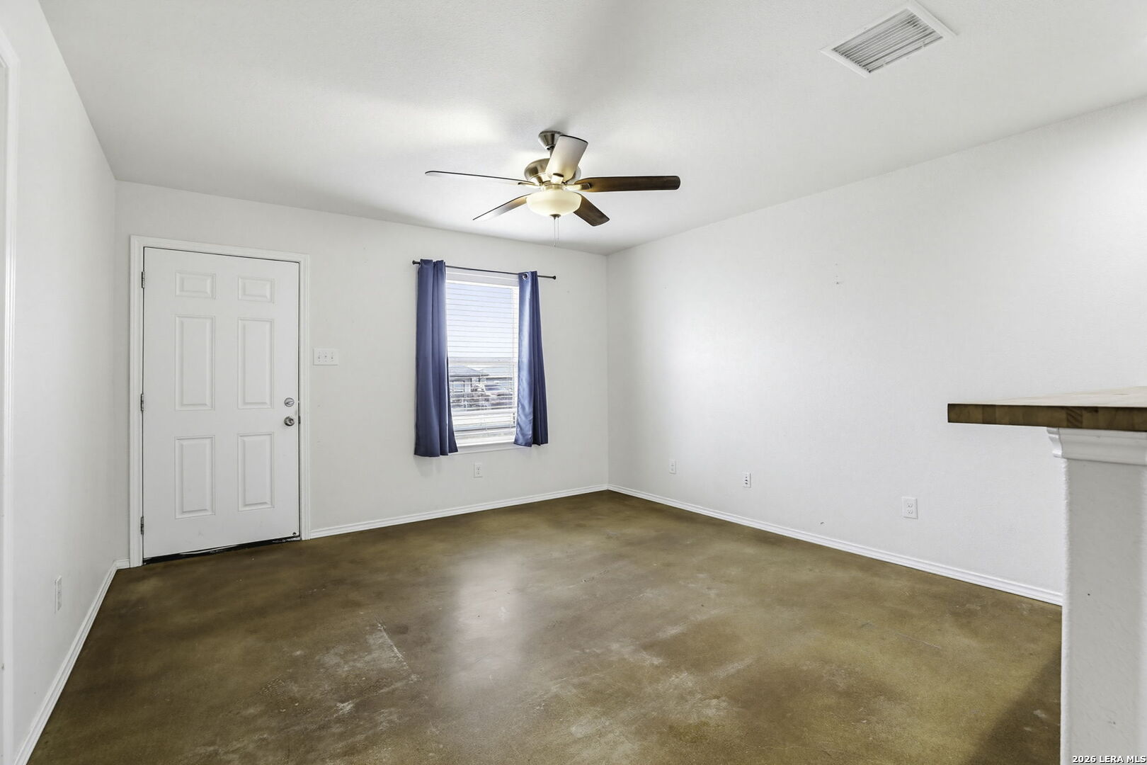 752 Cimarron, Unit B Spring Branch, TX 78070 - Photo 2 of 23 an empty room with windows and fan