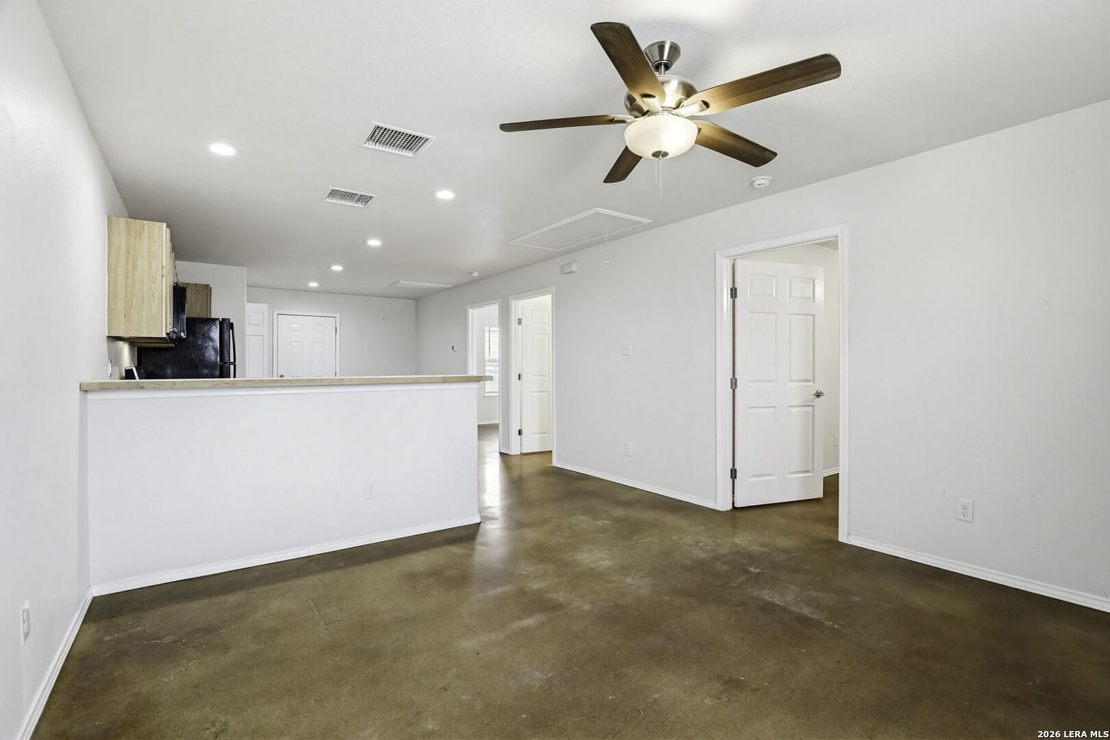752 Cimarron, Unit B Spring Branch, TX 78070 - Photo 4 of 23 a view of an empty room with kitchen furniture and a ceiling fan