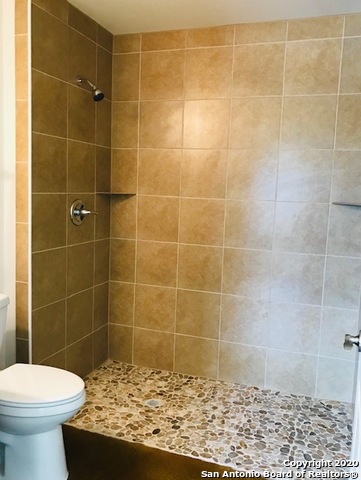 752 Cimarron, Unit B Spring Branch, TX 78070 - Photo 4 of 6 a bathroom with a sink toilet and shower