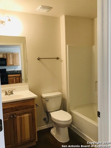 752 Cimarron, Unit B Spring Branch, TX 78070 - Photo 5 of 6 a bathroom with a sink a toilet and shower