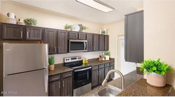 a kitchen with a refrigerator and a sink